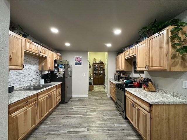 86 Steamboat Way W, Thompson Falls, MT 59873 - kitchen featuring stainless steel appliances, light wood-style flooring, recessed lighting, decorative backsplash, and light stone countertops