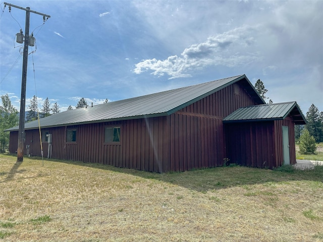 86 Steamboat Way W, Thompson Falls, MT 59873 - view of side of property with board and batten siding, an outbuilding, a yard, and a metal roof