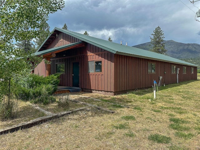 86 Steamboat Way W, Thompson Falls, MT 59873 - view of property exterior with board and batten siding, a lawn, and a mountain view
