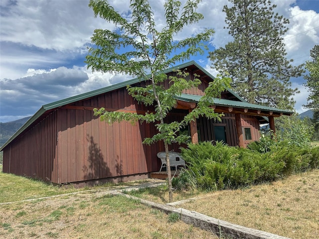 86 Steamboat Way W, Thompson Falls, MT 59873 - view of side of property featuring a metal roof, a lawn, and board and batten siding
