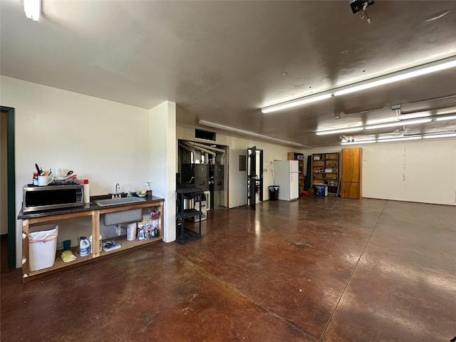 86 Steamboat Way W, Thompson Falls, MT 59873 - garage featuring a sink and freestanding refrigerator