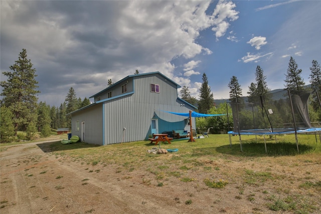 86 Steamboat Way W, Thompson Falls, MT 59873 - rear view of property with a trampoline and a lawn