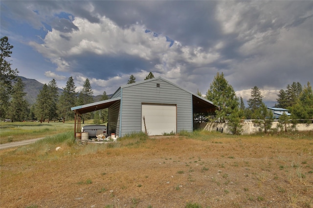 86 Steamboat Way W, Thompson Falls, MT 59873 - garage with a garage, a mountain view, and dirt driveway