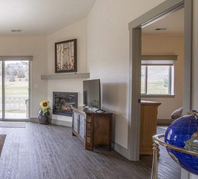 281 W Nicklaus Ave, Kalispell, MT 59901 - living area with wood finished floors, a glass covered fireplace, and plenty of natural light