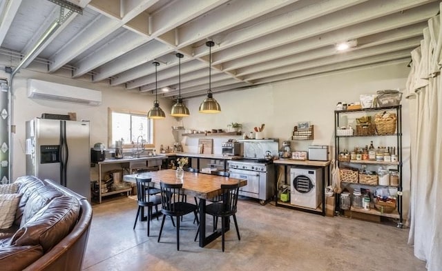 1210 Grand Fir Rd, Bigfork, MT 59911 - dining area featuring a wall unit AC, washer / clothes dryer, and concrete floors