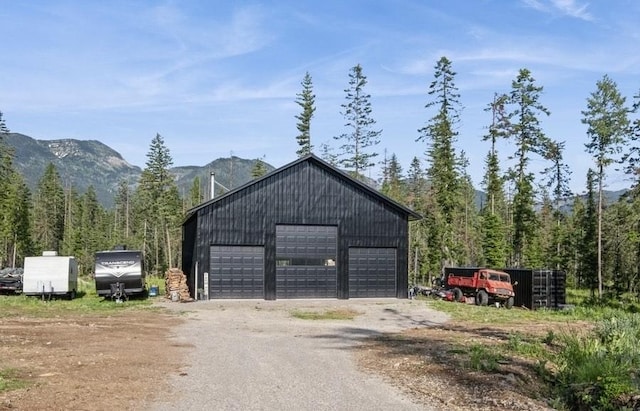 1210 Grand Fir Rd, Bigfork, MT 59911 - detached garage featuring a wooded view and a mountain view