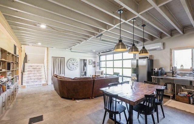 1210 Grand Fir Rd, Bigfork, MT 59911 - dining space featuring concrete floors and an AC wall unit