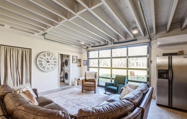 1210 Grand Fir Rd, Bigfork, MT 59911 - living room featuring stacked washing machine and dryer and concrete floors