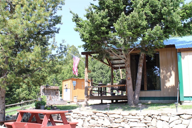 6570 Blossburg Rd, Canyon Creek, MT 59633 - view of side of property with a wooden deck, a storage shed, and board and batten siding