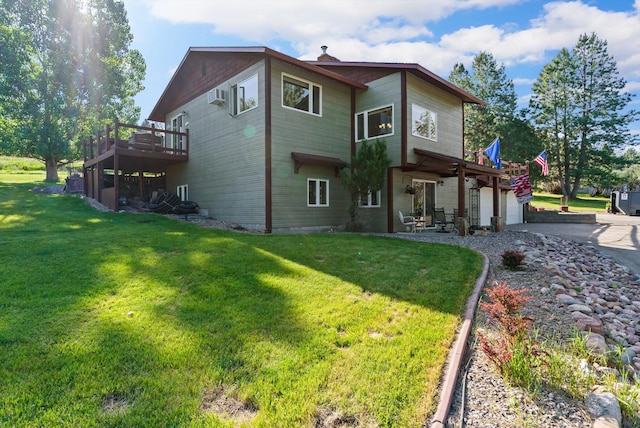 6350 S Meadowwood Ln, Missoula, MT 59803 - rear view of property with a lawn, driveway, a wooden deck, and a garage