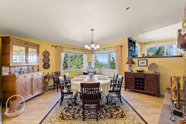 6350 S Meadowwood Ln, Missoula, MT 59803 - dining room with light wood-type flooring and a chandelier