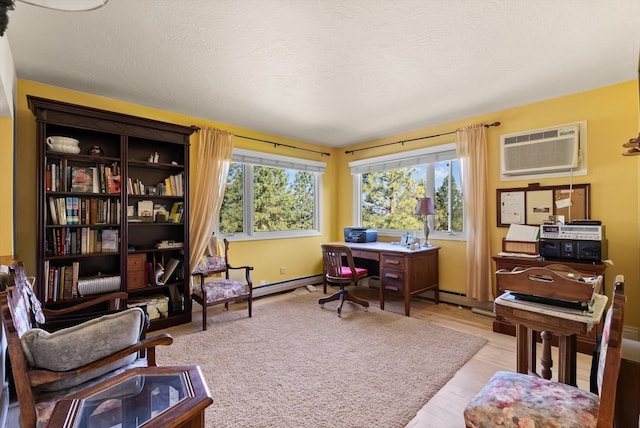 6350 S Meadowwood Ln, Missoula, MT 59803 - home office with a wall mounted AC, light wood-style floors, and baseboard heating