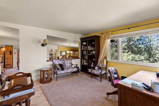 6350 S Meadowwood Ln, Missoula, MT 59803 - home office featuring light wood finished floors, a chandelier, and a textured ceiling