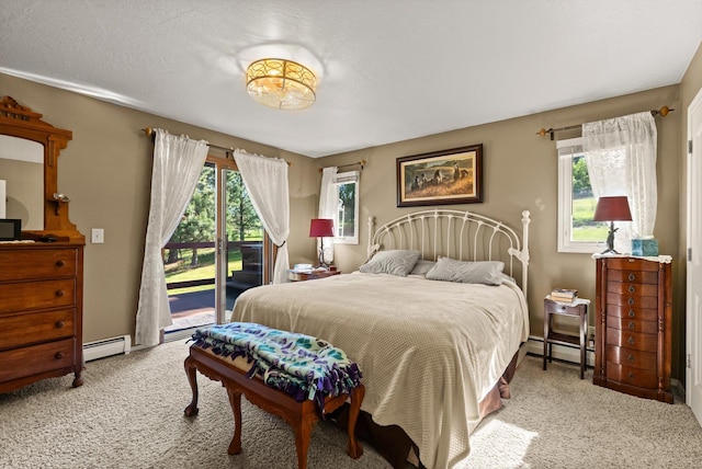 6350 S Meadowwood Ln, Missoula, MT 59803 - bedroom featuring access to exterior, carpet, multiple windows, and a baseboard radiator