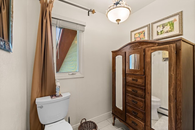 6350 S Meadowwood Ln, Missoula, MT 59803 - half bathroom featuring a baseboard heating unit and tile patterned floors