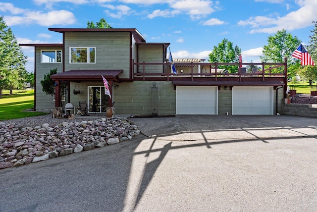 6350 S Meadowwood Ln, Missoula, MT 59803 - view of front of property with asphalt driveway, a garage, and a wooden deck