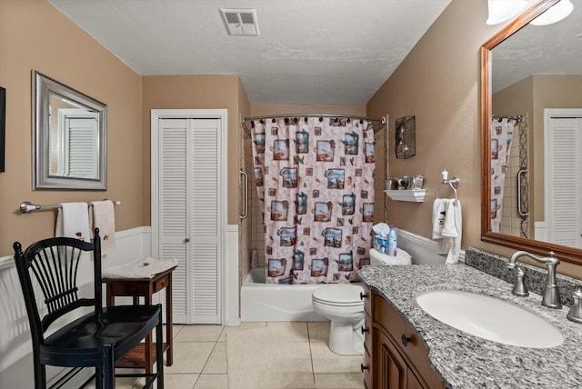 6350 S Meadowwood Ln, Missoula, MT 59803 - full bath with a closet, vanity, tile patterned flooring, shower / tub combo with curtain, and a textured ceiling