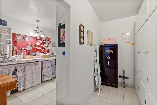 6350 S Meadowwood Ln, Missoula, MT 59803 - corridor featuring light tile patterned floors and a chandelier