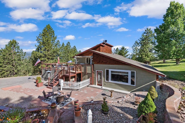 6350 S Meadowwood Ln, Missoula, MT 59803 - rear view of house with a wooden deck and a patio area