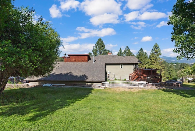 6350 S Meadowwood Ln, Missoula, MT 59803 - rear view of house with a wooden deck, a chimney, and a shingled roof