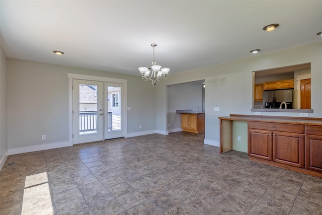 701 E Lewis St, East Helena, MT 59635 - unfurnished living room with a chandelier and french doors