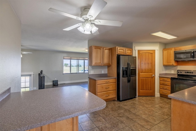 701 E Lewis St, East Helena, MT 59635 - kitchen with refrigerator with ice dispenser, stainless steel microwave, black electric range, ceiling fan, and dark countertops