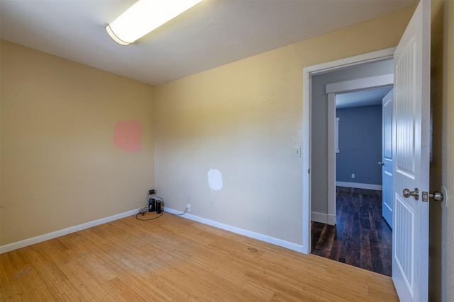 701 E Lewis St, East Helena, MT 59635 - spare room featuring wood finished floors and baseboards