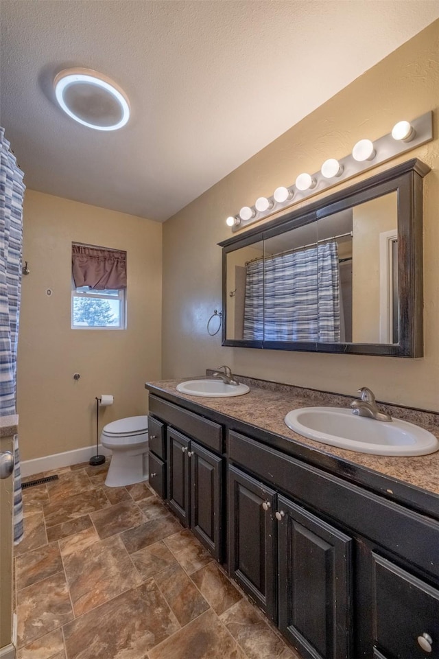 701 E Lewis St, East Helena, MT 59635 - full bathroom with double vanity and stone finish flooring