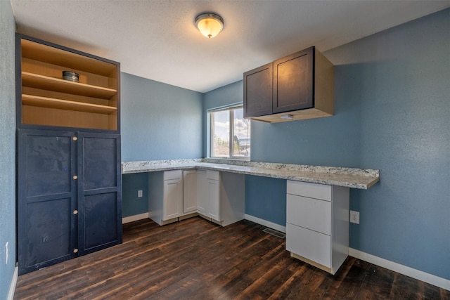 701 E Lewis St, East Helena, MT 59635 - unfurnished office with built in desk and dark wood-style flooring