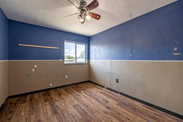 701 E Lewis St, East Helena, MT 59635 - unfurnished room with wood finished floors, a ceiling fan, a textured wall, and a textured ceiling