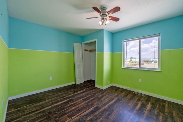 701 E Lewis St, East Helena, MT 59635 - unfurnished bedroom featuring dark wood-style flooring, a closet, and a ceiling fan