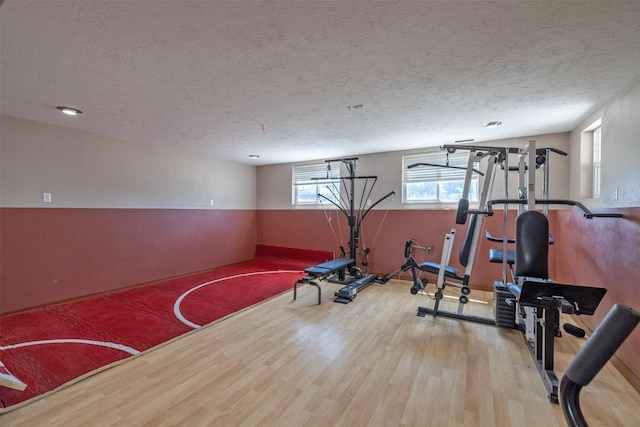 701 E Lewis St, East Helena, MT 59635 - exercise room featuring a textured ceiling and wood finished floors