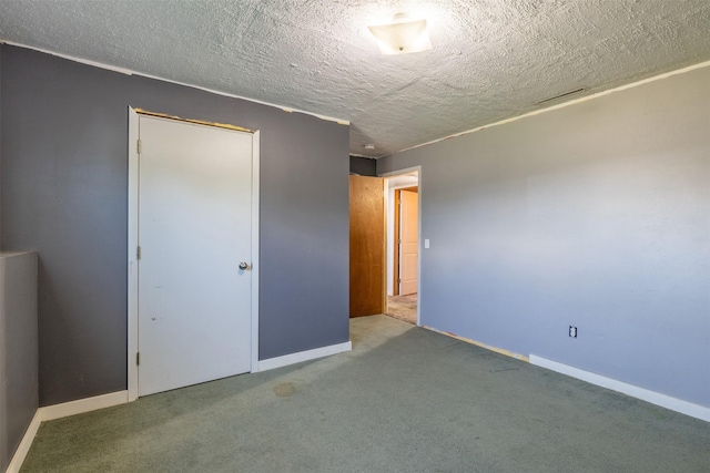 701 E Lewis St, East Helena, MT 59635 - unfurnished bedroom featuring carpet flooring and a textured ceiling