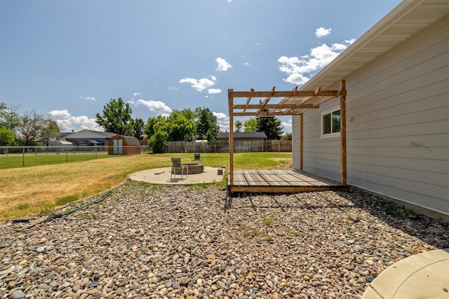 701 E Lewis St, East Helena, MT 59635 - fenced backyard with an outdoor fire pit, a pergola, a patio area, and a deck