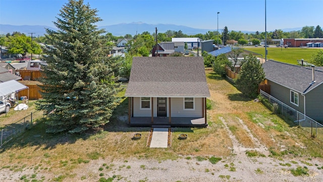 324 N Pine St, Townsend, MT 59644 - view of front of property featuring a mountain view, a residential view, roof with shingles, and driveway