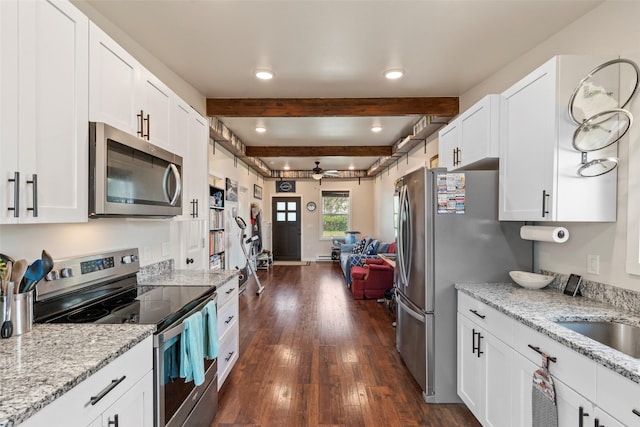 324 N Pine St, Townsend, MT 59644 - kitchen with appliances with stainless steel finishes, a ceiling fan, dark wood-type flooring, white cabinetry, and beamed ceiling