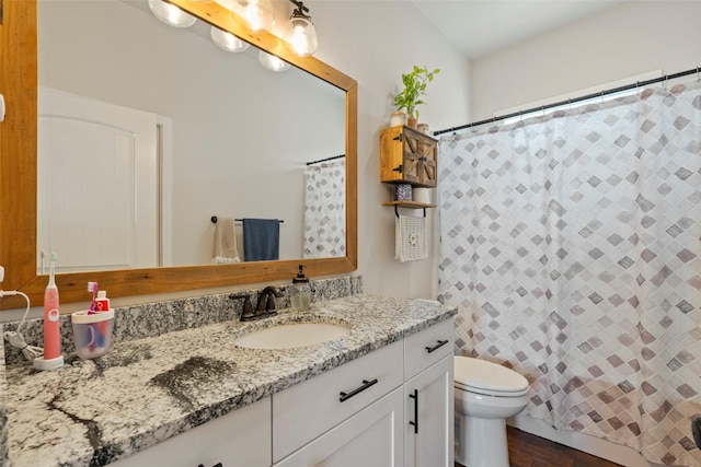 324 N Pine St, Townsend, MT 59644 - bathroom with vanity, a shower with shower curtain, and wood finished floors