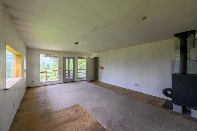 456 Gould Rd, Eureka, MT 59917 - unfurnished living room with wood finished floors and a wood stove