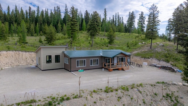 4475 Star Meadows Rd, Whitefish, MT 59937 - back of house featuring a wooden deck and a metal roof