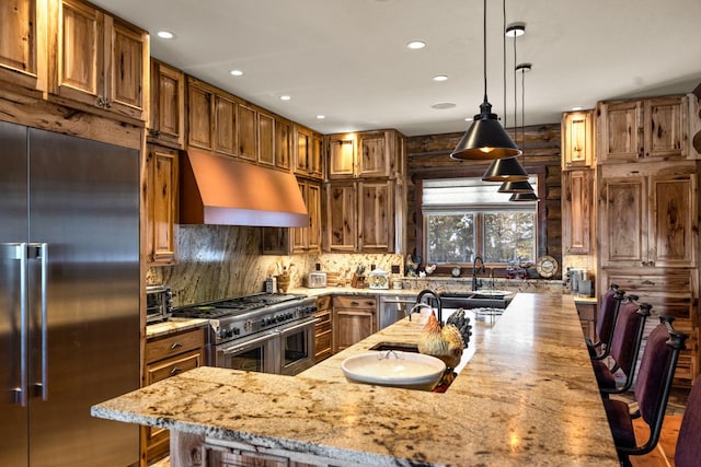 4475 Star Meadows Rd, Whitefish, MT 59937 - kitchen with high quality appliances, under cabinet range hood, light stone counters, recessed lighting, and tasteful backsplash