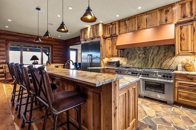 4475 Star Meadows Rd, Whitefish, MT 59937 - kitchen with high quality appliances, rustic walls, range hood, recessed lighting, and a kitchen island with sink