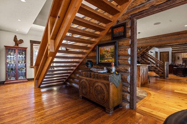 4475 Star Meadows Rd, Whitefish, MT 59937 - staircase with hardwood / wood-style floors, log walls, and recessed lighting
