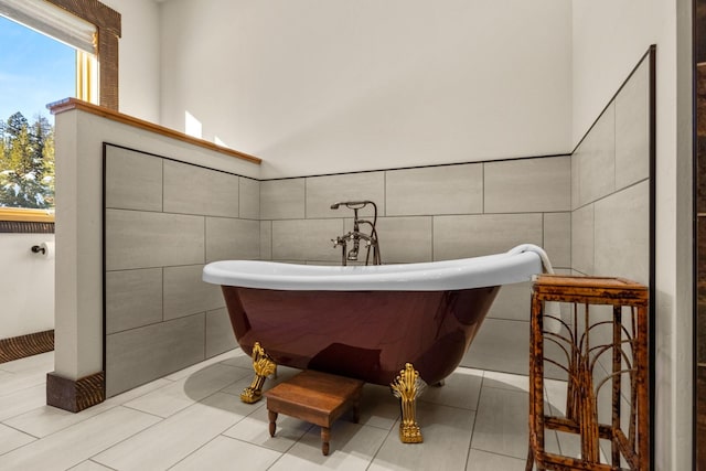 4475 Star Meadows Rd, Whitefish, MT 59937 - full bathroom with tile walls, a freestanding tub, and tile patterned flooring