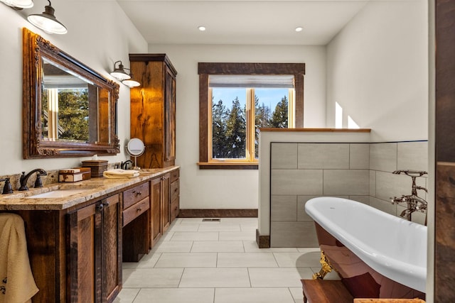4475 Star Meadows Rd, Whitefish, MT 59937 - full bath with a freestanding bath, double vanity, tile patterned floors, and recessed lighting