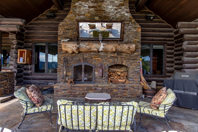 4475 Star Meadows Rd, Whitefish, MT 59937 - view of patio / terrace featuring an outdoor stone fireplace and area for grilling
