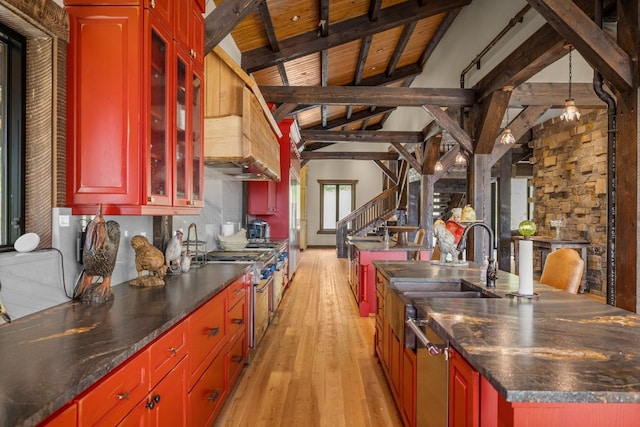 4475 Star Meadows Rd, Whitefish, MT 59937 - kitchen with light wood-type flooring, a kitchen island with sink, dark countertops, wood ceiling, and reddish brown cabinets