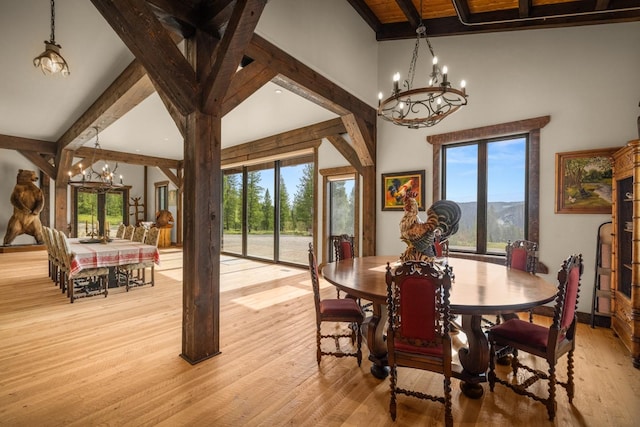 4475 Star Meadows Rd, Whitefish, MT 59937 - dining area featuring a chandelier, beamed ceiling, light wood finished floors, and a mountain view