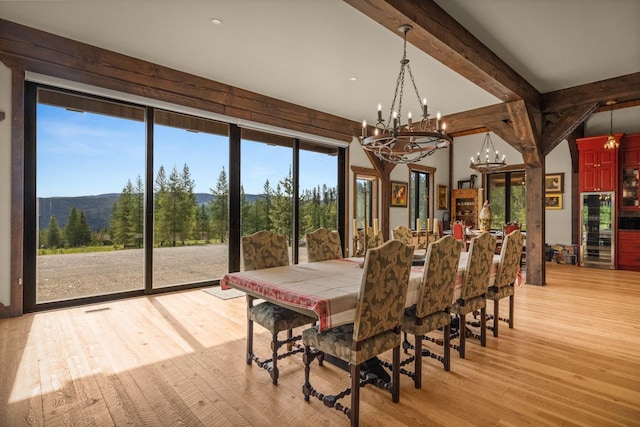4475 Star Meadows Rd, Whitefish, MT 59937 - dining room with light wood-style floors, a chandelier, beverage cooler, and a mountain view