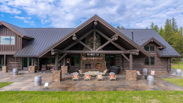 4475 Star Meadows Rd, Whitefish, MT 59937 - back of property with log exterior, a patio, a metal roof, and stone siding