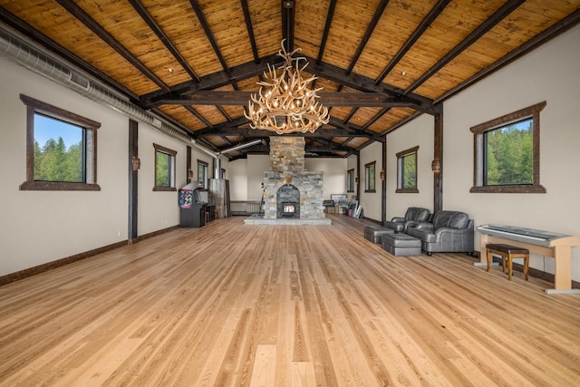 4475 Star Meadows Rd, Whitefish, MT 59937 - unfurnished living room featuring a chandelier, a wooden ceiling with exposed beams, light wood-style floors, and high vaulted ceiling